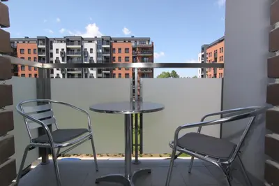 a table and two chairs on a balcony with a view at Apartment Moonstone 3 in Bežanija