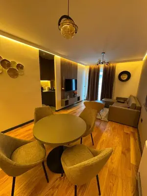 a living room with a table and chairs and a couch at Todd in Belgrade