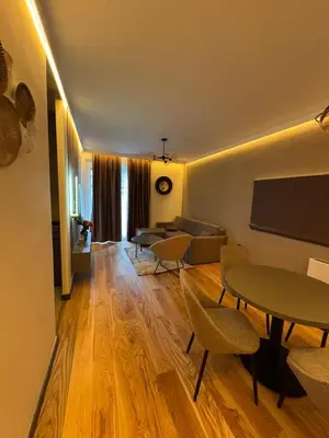 a living room with a couch and a table and chairs at Todd in Belgrade