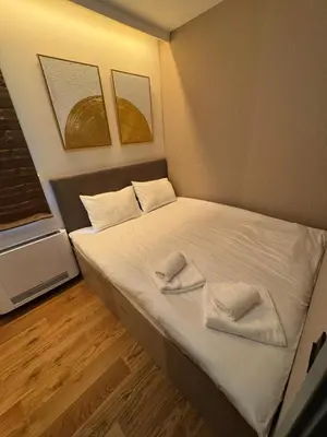 a small bedroom with a bed with two towels on it at Todd in Belgrade