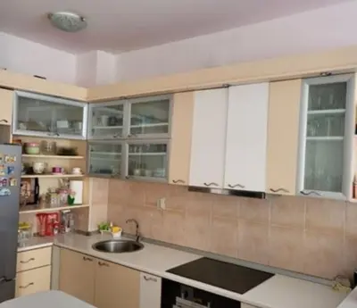 a kitchen with white cabinets and a sink at Vila Ana 1 in Belgrade