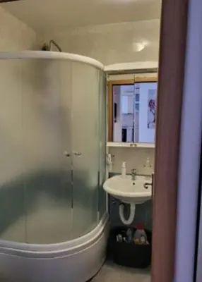 a bathroom with a glass shower and a sink at Vila Ana 1 in Belgrade