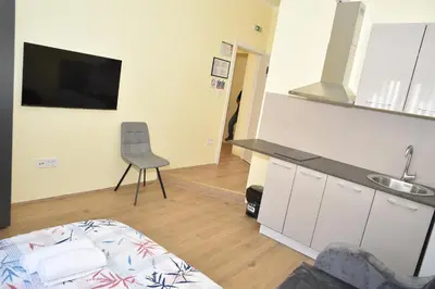 a kitchen with a sink and a chair in a room at mir rooms and apartments in Belgrade