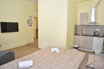 a bedroom with a bed with two white towels on it at mir rooms and apartments in Belgrade