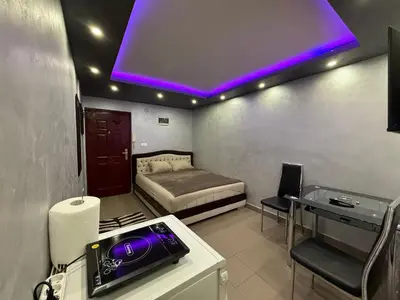 a room with a bed and a purple light at Element Apartman Obrenovac, Privatni Parking in Obrenovac