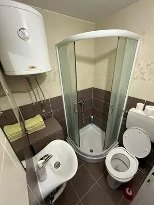 a small bathroom with a toilet and a sink at Element Apartman Obrenovac, Privatni Parking in Obrenovac