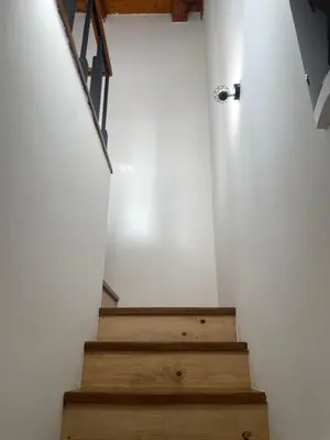 a staircase in a room with white walls and wooden floors at Apartmani Kersbaum in Belgrade