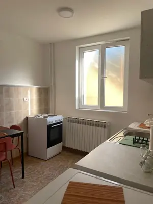 a kitchen with a stove and a window at Apartmani Kersbaum in Belgrade