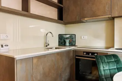 a kitchen with a sink and a stove at Center Queen size bed Sofa additional living area for 2 in Belgrade