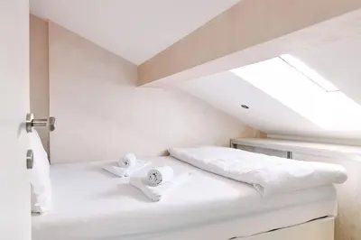 a room with a bed with two towels on it at Center Queen size bed Sofa additional living area for 2 in Belgrade