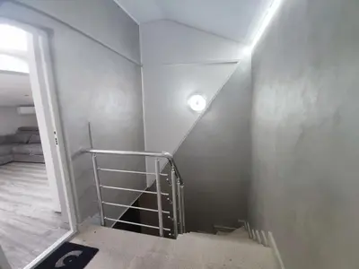 a staircase with a light on the side of a wall at Center Queen size bed Sofa additional living area for 2 in Belgrade