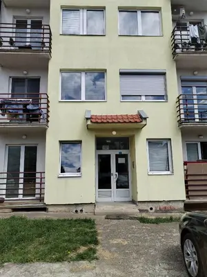 a yellow house with a door and a balcony at Stan na dan MARA in Mladenovac