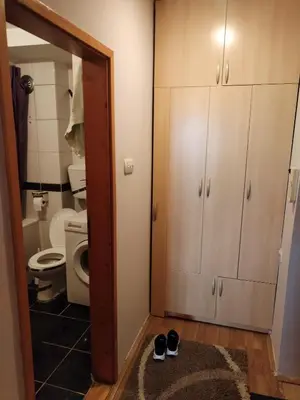 a bathroom with a toilet and a pair of shoes at Stan na dan MARA in Mladenovac