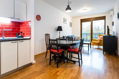 a kitchen and dining room with a table and chairs at Cozy Heaven in Belgrade