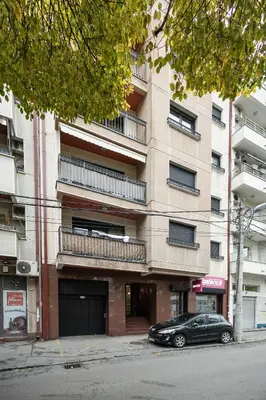 a black car parked in front of a building at Cozy Heaven in Belgrade