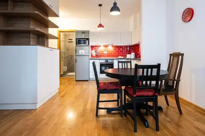 a kitchen and dining room with a table and chairs at Cozy Heaven in Belgrade