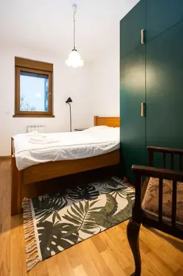 a bedroom with a bed and a green wall at Cozy Heaven in Belgrade