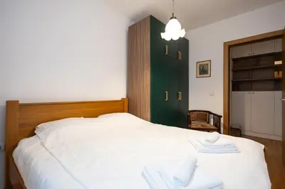a bedroom with a bed with towels on it at Cozy Heaven in Belgrade