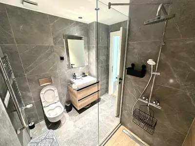a bathroom with a toilet and a sink and a shower at River Sight Studio - BW SIMPHONY in Belgrade