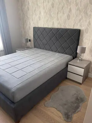 a bedroom with a large bed and two night stands at Belgrade Waterfront Nora in Belgrade