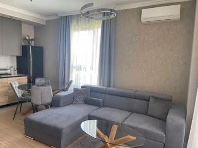 a living room with a couch and a table at Belgrade Waterfront Nora in Belgrade