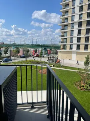 a balcony with a view of a park and a building at Belgrade Waterfront Nora in Belgrade