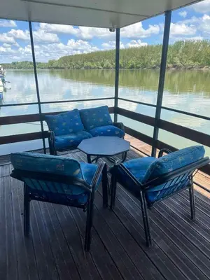 a boat with chairs and a table on the deck at SplavTisa-Titel in Titel