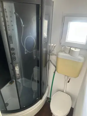 a small bathroom with a shower and a toilet at SplavTisa-Titel in Titel