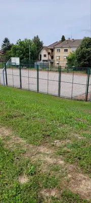 a fence in the middle of a soccer field at SplavTisa-Titel in Titel