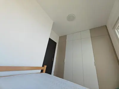 a bedroom with a bed and a closet at Airport sunset apartment in Ledine