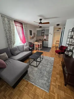 a living room with a couch and a table at Flower Home Belgrade in Belgrade