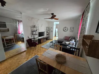 a living room with a couch and a table at Flower Home Belgrade in Belgrade