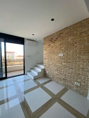 a brick wall in a room with a staircase at ast13r 12451f in Belgrade