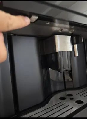 a person is using a coffee machine at Taurunum lux Apartment 30 in Belgrade