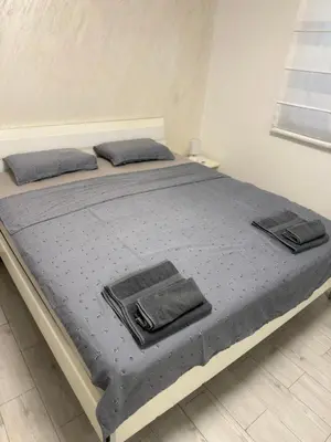 a bed with blue sheets and pillows on it at Taurunum lux Apartment 30 in Belgrade