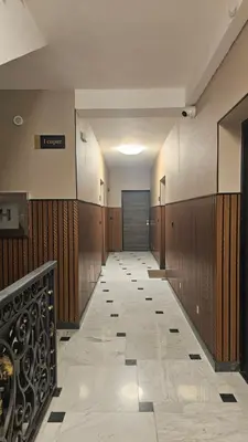 a hallway of a hospital with wood paneling and a door at Magnolija stan na dan in Belgrade