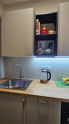 a kitchen with a sink and a counter top at Magnolija stan na dan in Belgrade