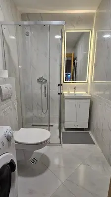 a bathroom with a shower and a toilet and a sink at Magnolija stan na dan in Belgrade
