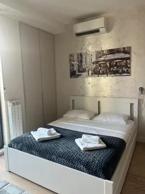 a bedroom with a bed with two towels on it at Belgrade Waterfront Cozy Studio in Belgrade