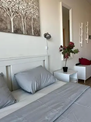 a bedroom with a bed and a picture on the wall at Belgrade Waterfront Cozy Studio in Belgrade