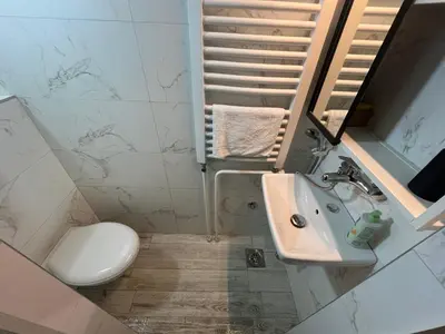 a small bathroom with a sink and a toilet at Studio MB in Belgrade