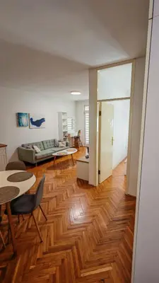 a living room with a couch and a wooden floor at Brod Trgovacka in Žarkovo