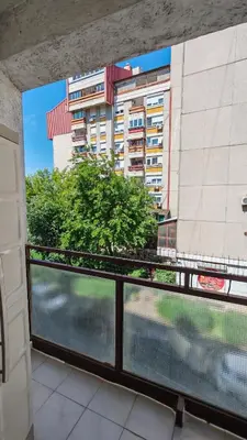 a balcony with a view of a building at Brod Trgovacka in Žarkovo