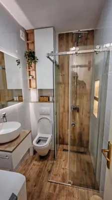 a bathroom with a toilet and a glass shower at Brod Trgovacka in Žarkovo