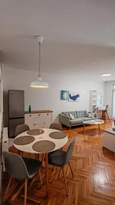 a living room with a table and chairs and a couch at Brod Trgovacka in Žarkovo