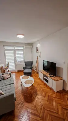 a living room with a couch and a tv at Brod Trgovacka in Žarkovo