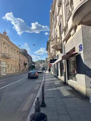 a car driving down a street next to a building at Apartment Ksenija in Belgrade