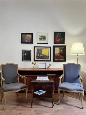 a desk with two chairs and a table with a lamp at Apartment Ksenija in Belgrade
