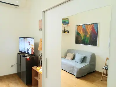 a living room with a sliding glass door with a couch at Vlada in Belgrade