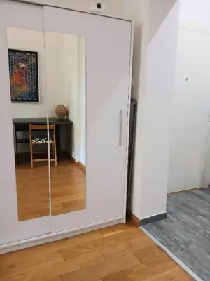 a sliding glass door in a room with a table at Vlada in Belgrade